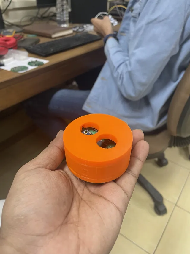The CARE prototype as I received it: an orange 3D-printed housing with two round openings