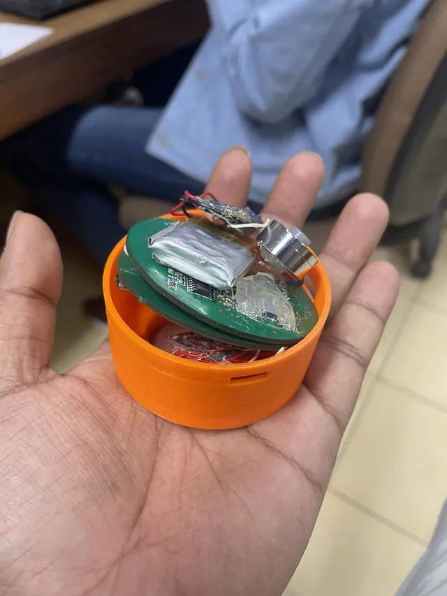 The prototype opened, showing two circuit boards, a battery and the sensors